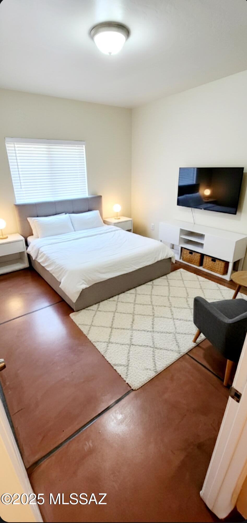 533 West San Xavier Road Tucson, AZ 85713 - Photo 15 of 21 a bedroom with a bed and a flat screen tv