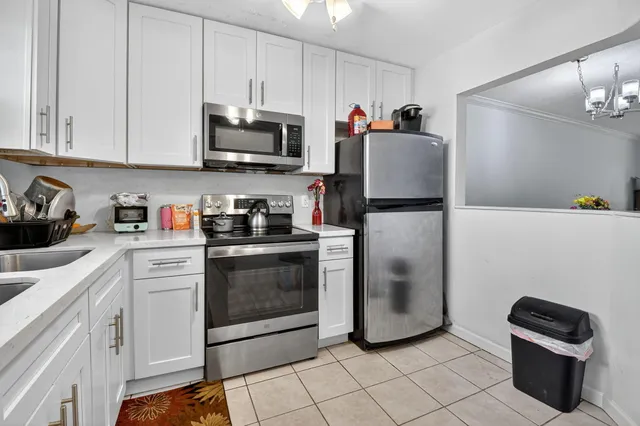 a kitchen with a refrigerator and cabinets