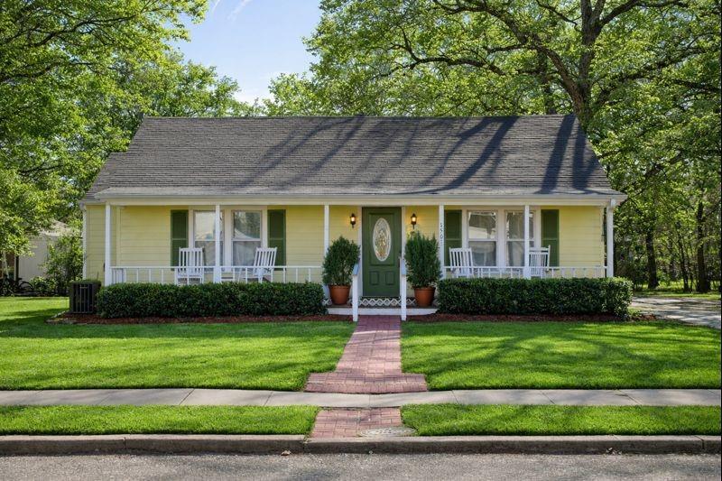 1505 Bonham Street Commerce, TX 75428 - Photo 2 of 38 Front of historical home at 1505 Bonham St. Grass and trees have been virtually enhanced to show the home's potential