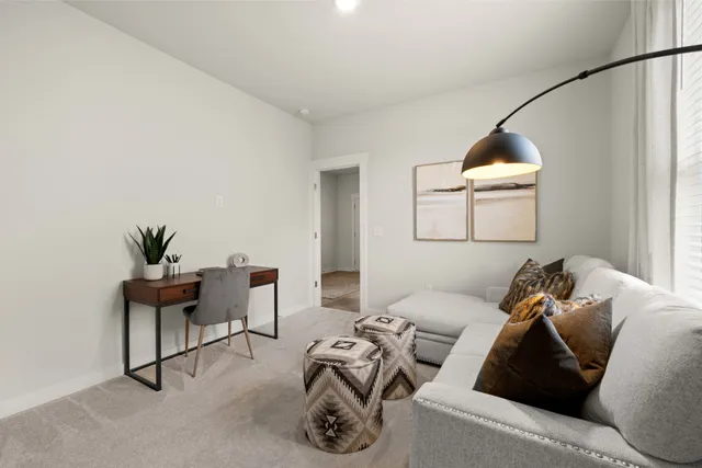 a living room with furniture and a potted plant