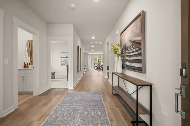 a view of a hallway view with wooden floor and staircase