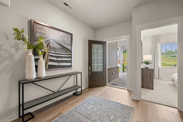 a living room with a potted plant on a dresser and a potted plant