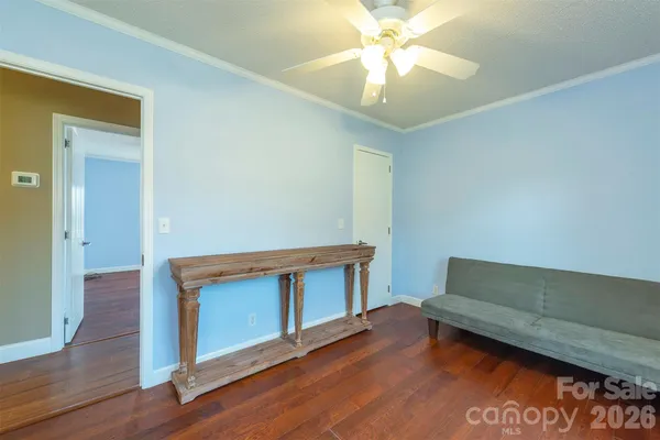a view of room with wooden floor and fan