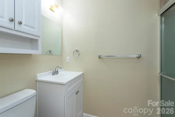 a bathroom with a sink a toilet and vanity