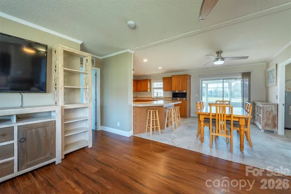 a view of a livingroom with furniture wooden floor and a flat screen tv