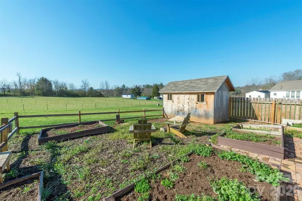 a view of a backyard with wooden fence