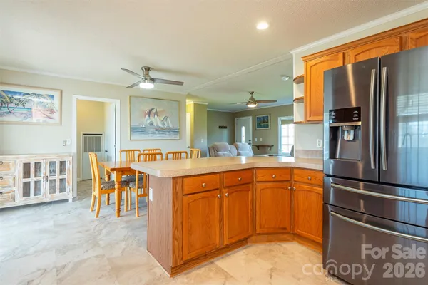 a large kitchen with stainless steel appliances granite countertop a refrigerator and a sink