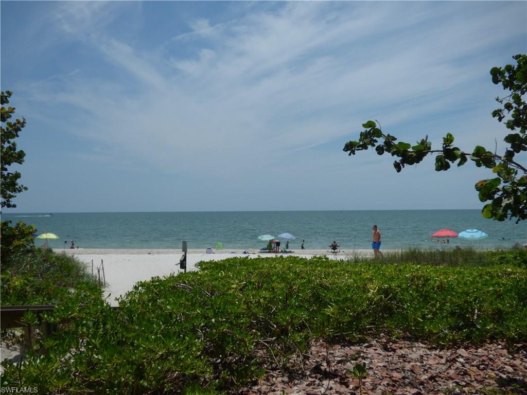 16211 Marsilea Place Naples, FL 34110 - Photo 23 of 25 a view of a lake with a building in background