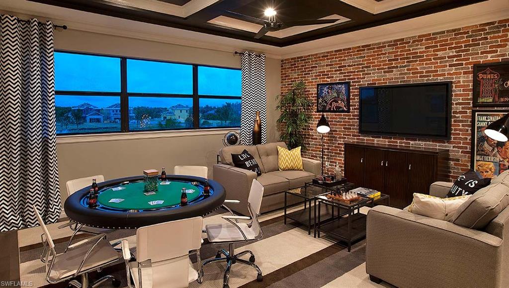 16211 Marsilea Place Naples, FL 34110 - Photo 3 of 25 a living room with furniture a flat screen tv and a fireplace