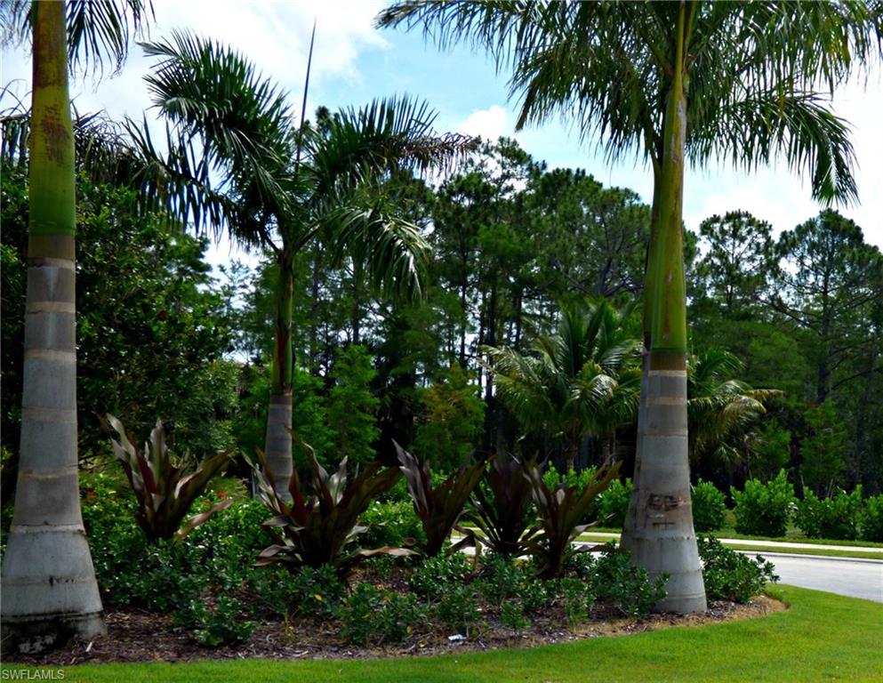 16211 Marsilea Place Naples, FL 34110 - Photo 8 of 25 a front view of multi story residential apartment building with yard and green space