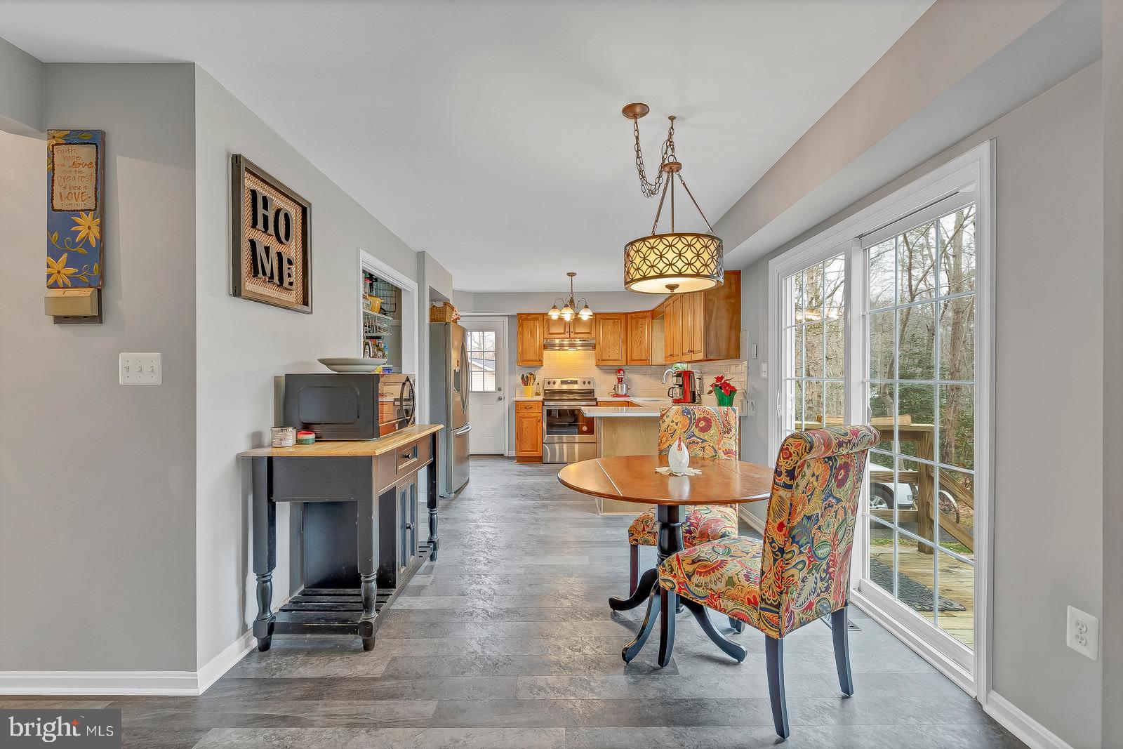 537 Platte Road Lusby, MD 20657 - Photo 13 of 33 a dining room with furniture a chandelier and wooden floor