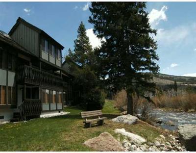 4770 Big Horn Road, Unit J3 Vail, CO 81657 - Photo 1 of 8 a backyard of a house with lawn chairs and a fire pit