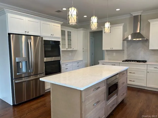 a kitchen with granite countertop a refrigerator oven a sink and dishwasher