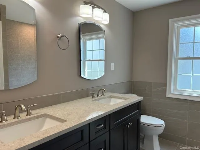 a bathroom with a sink toilet and a mirror