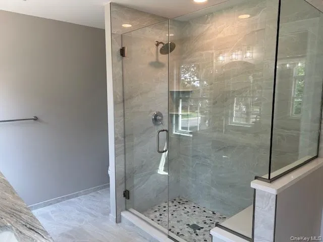 a bathroom with a glass shower door