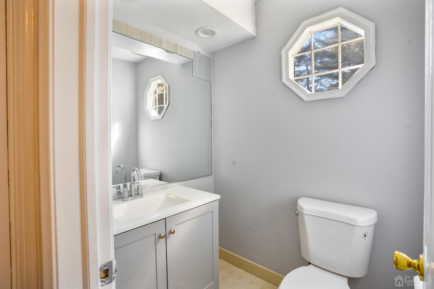 303 Timber Oaks Road Edison, NJ 08820 - Photo 11 of 28 a bathroom with a toilet a sink and mirror