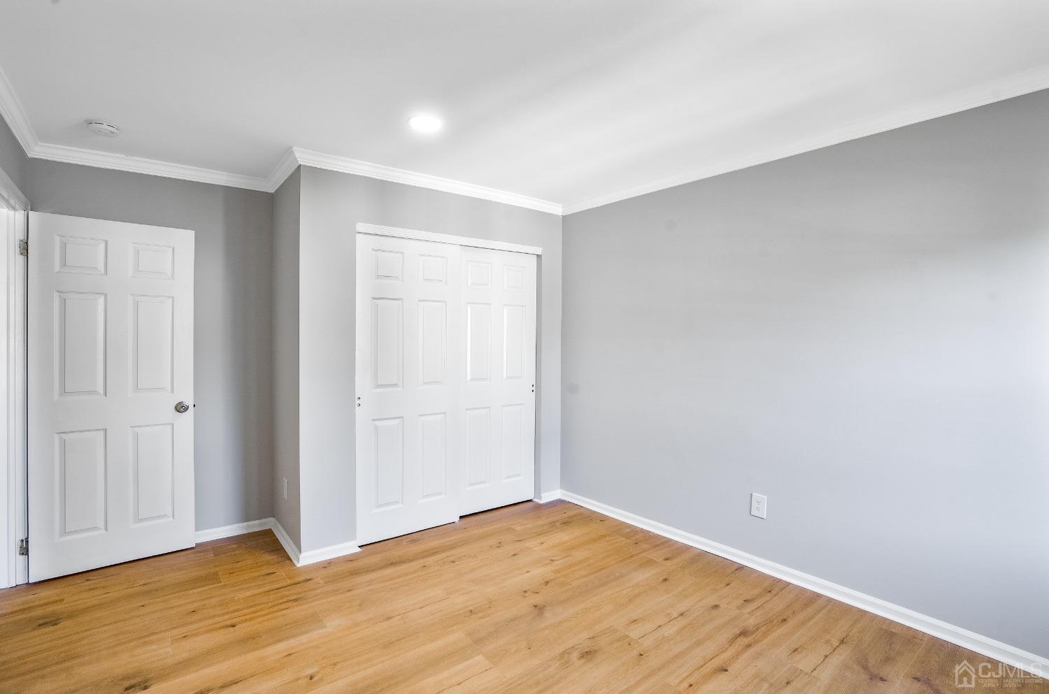 303 Timber Oaks Road Edison, NJ 08820 - Photo 13 of 28 a view of an empty room with wooden floor