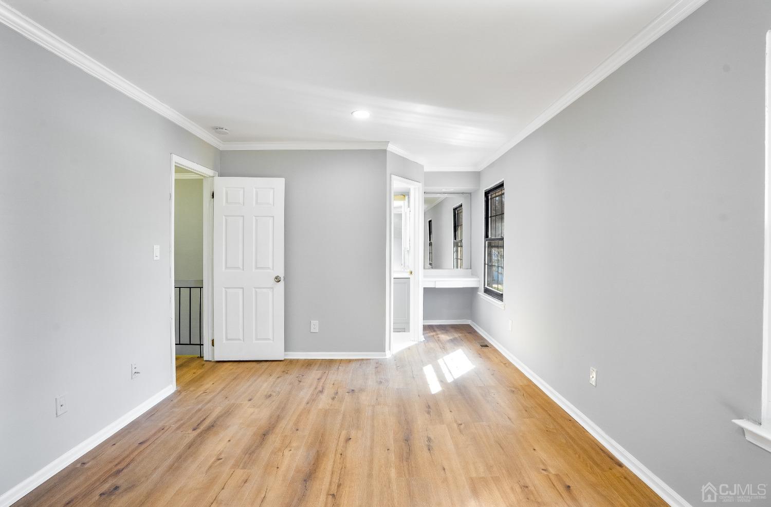 303 Timber Oaks Road Edison, NJ 08820 - Photo 20 of 28 a view of a big room with wooden floor and windows