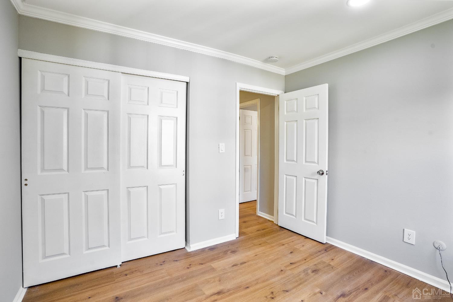 303 Timber Oaks Road Edison, NJ 08820 - Photo 21 of 28 a view of an empty room with wooden floor