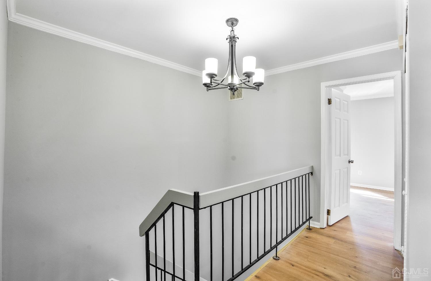 303 Timber Oaks Road Edison, NJ 08820 - Photo 22 of 28 a view of a hallway with a chandelier