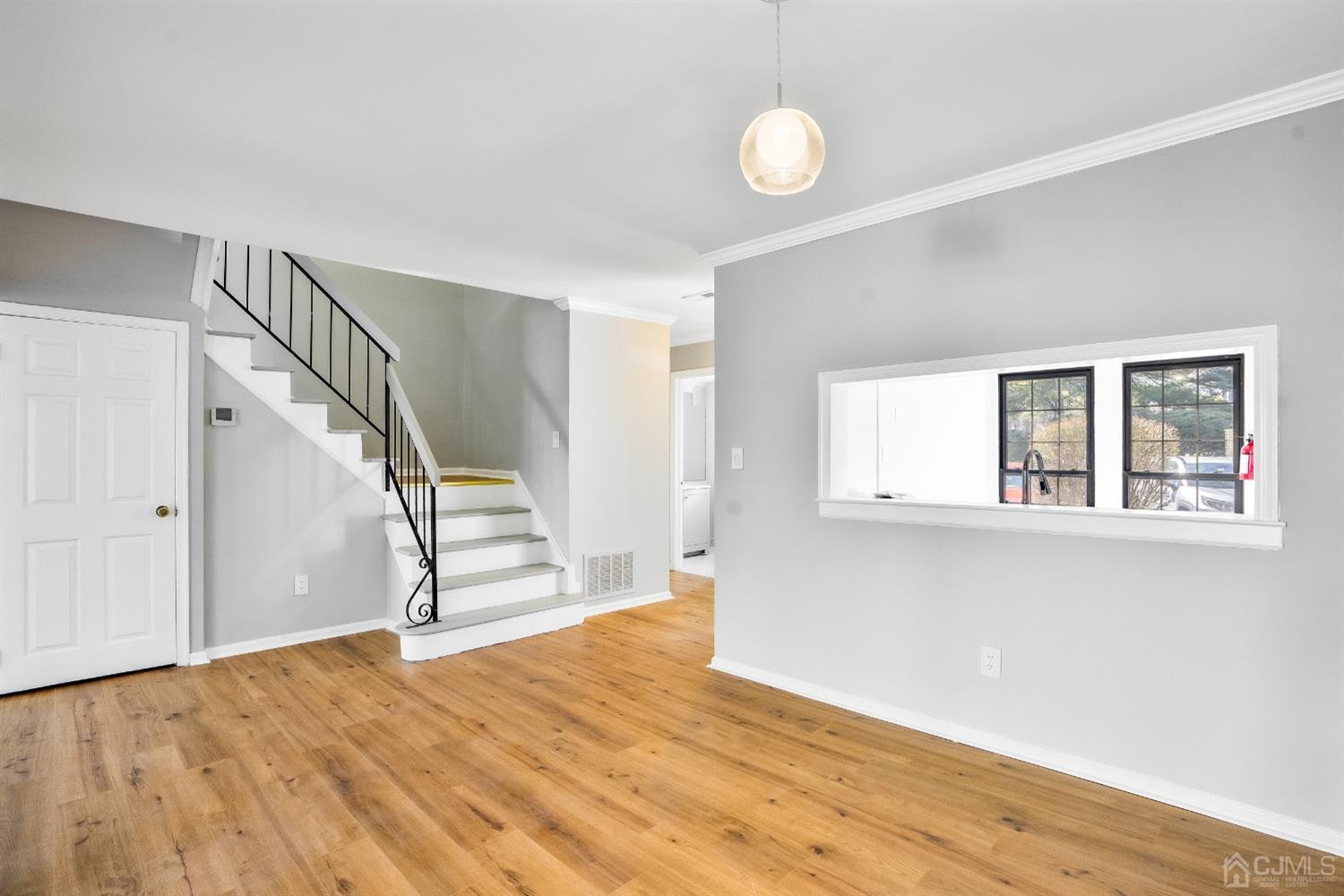 303 Timber Oaks Road Edison, NJ 08820 - Photo 3 of 28 a view of empty room with wooden floor and fan
