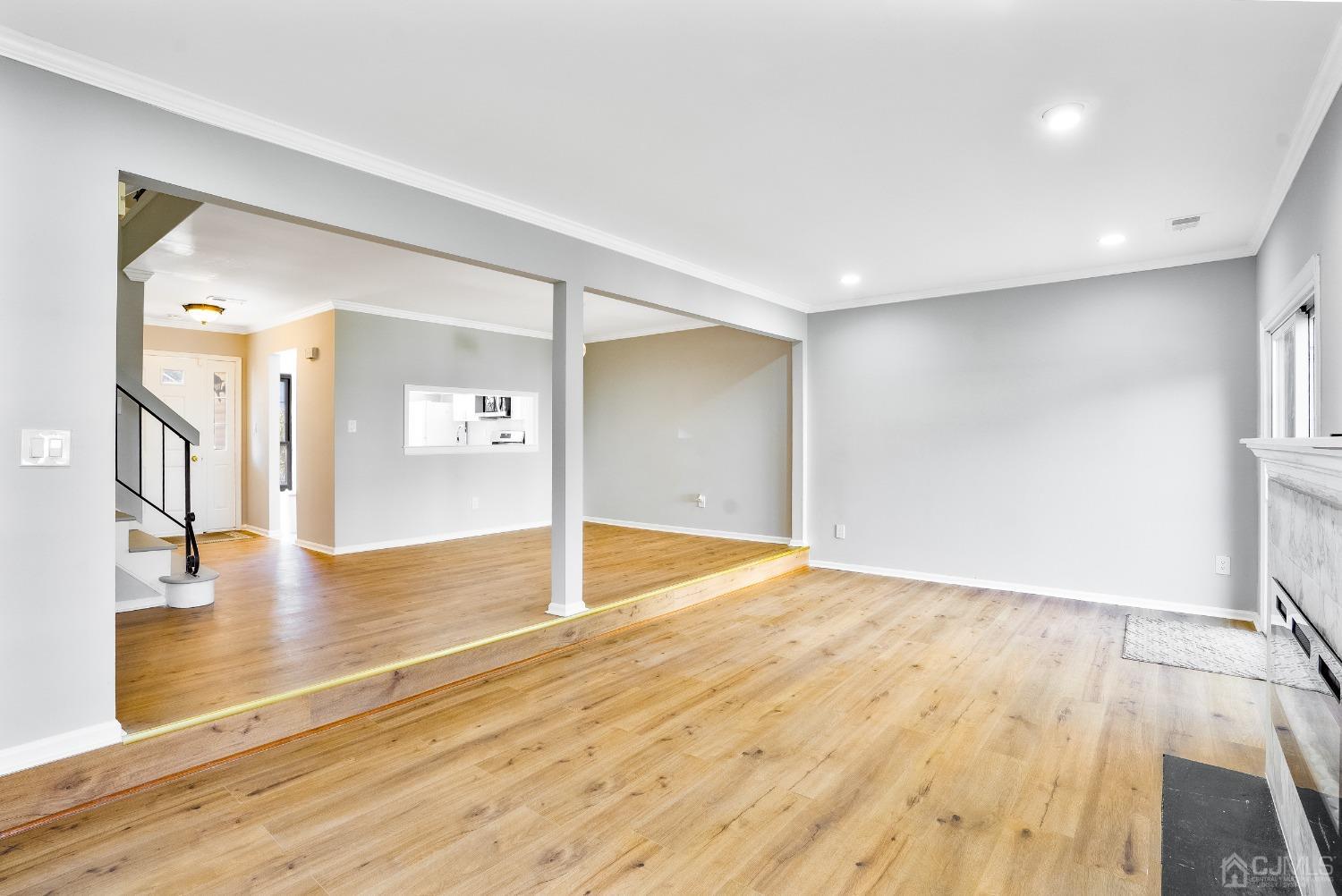 303 Timber Oaks Road Edison, NJ 08820 - Photo 4 of 28 a view of empty room with wooden floor and a fireplace