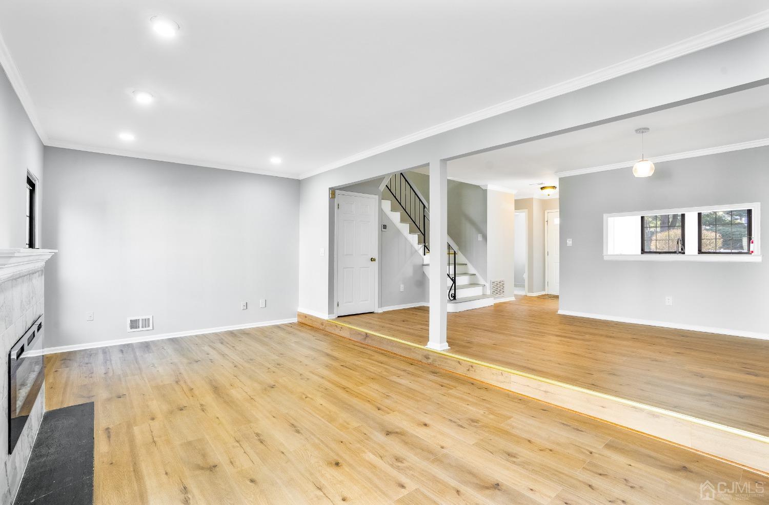 303 Timber Oaks Road Edison, NJ 08820 - Photo 5 of 28 a view of empty room with wooden floor and fan
