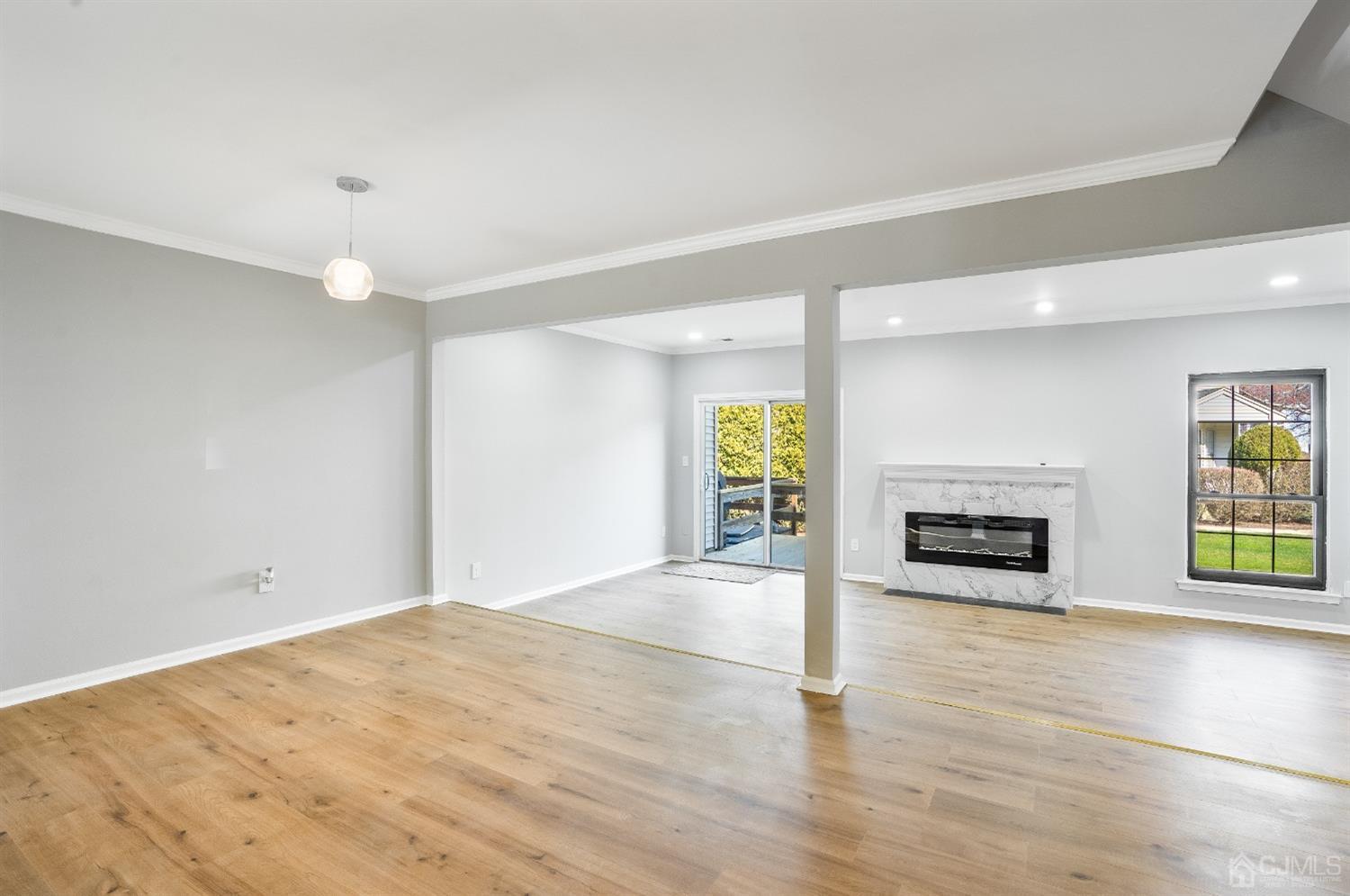 303 Timber Oaks Road Edison, NJ 08820 - Photo 6 of 28 an empty room with windows and fireplace