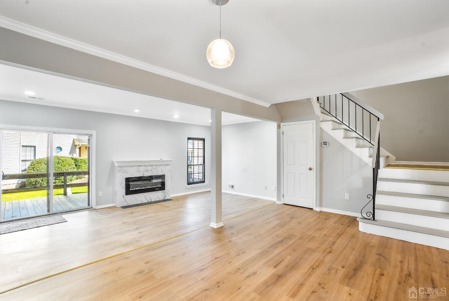 303 Timber Oaks Road Edison, NJ 08820 - Photo 7 of 28 a view of an empty room with a fireplace and a window