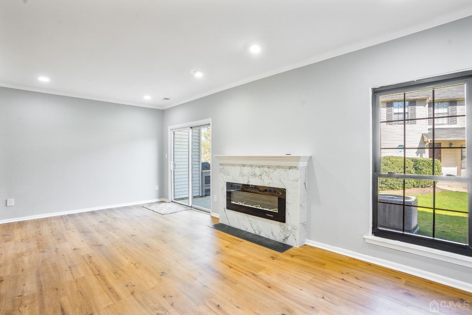 303 Timber Oaks Road Edison, NJ 08820 - Photo 8 of 28 a view of empty room with wooden floor and fireplace