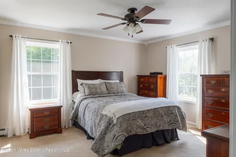 a bedroom with a bed a dresser and a window