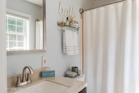 a bathroom with a sink and mirror