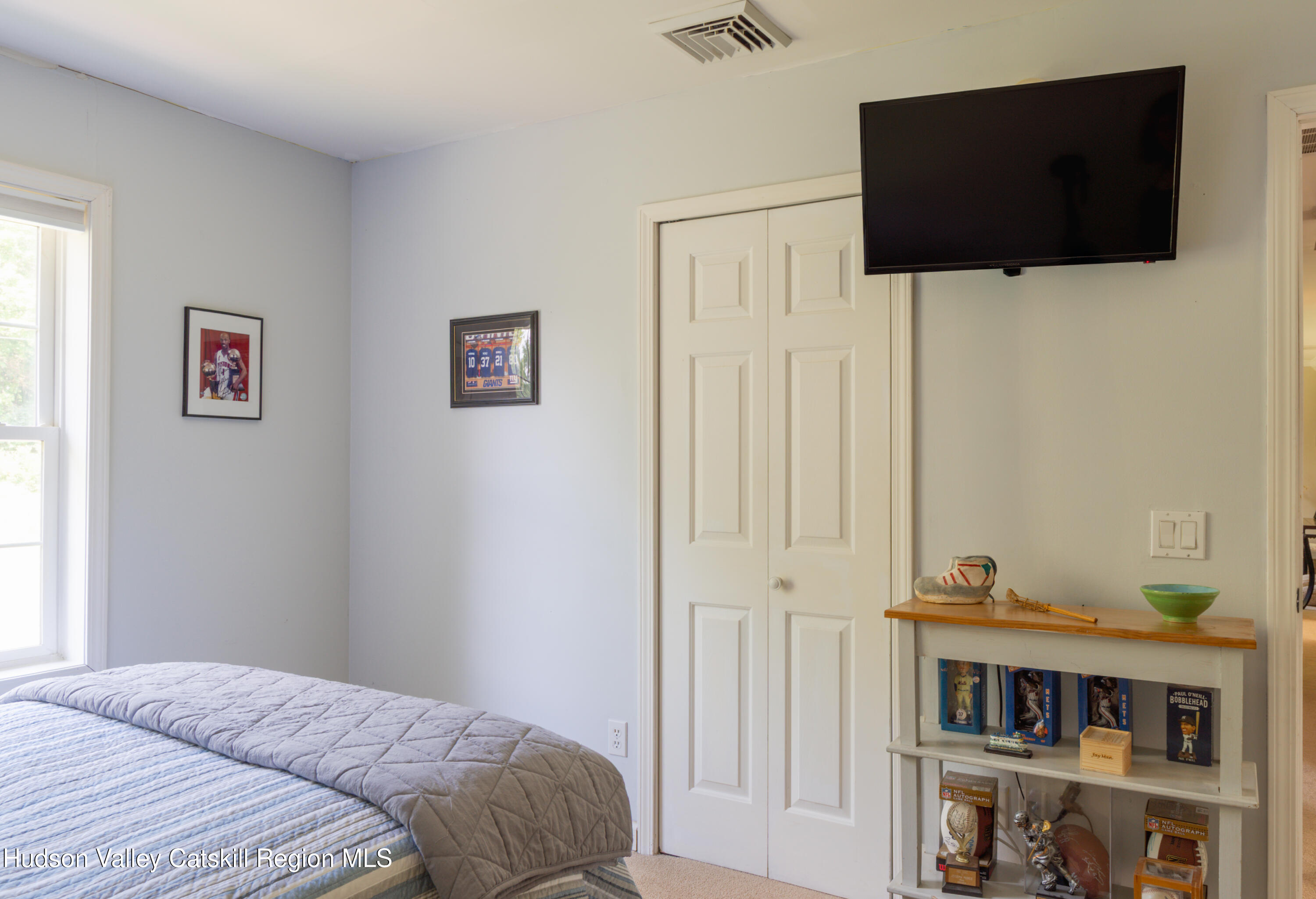 71 Duck Pond Road Stone Ridge, NY 12484 - Photo 18 of 35 a bedroom with a bed and a flat screen tv