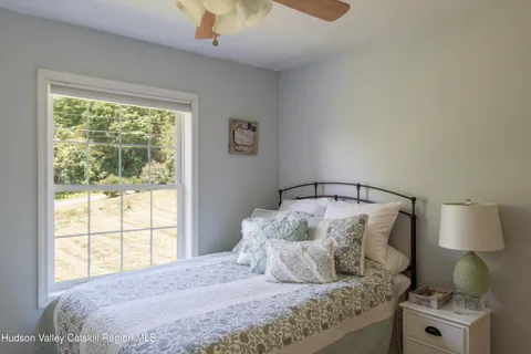 a bedroom with a large bed and a window