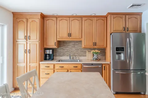 a kitchen with stainless steel appliances granite countertop a refrigerator sink and cabinets