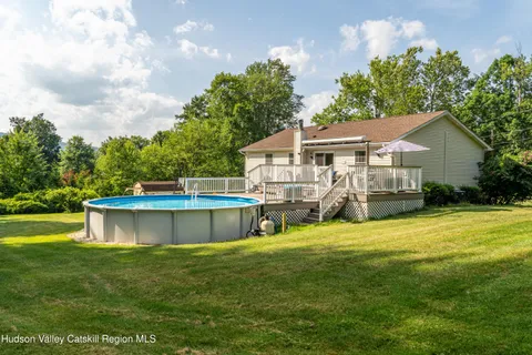 a view of a house with a yard balcony and sitting area