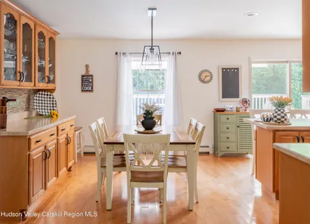 a view of a dining room with furniture window and wooden floor