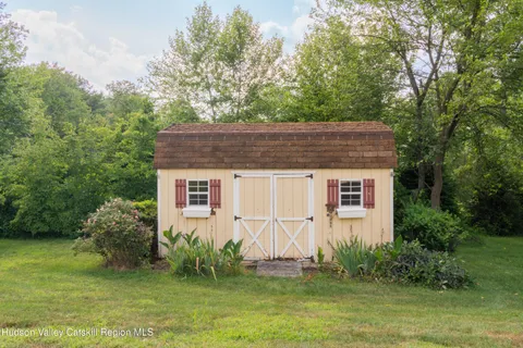 a house that has a tree in front of it