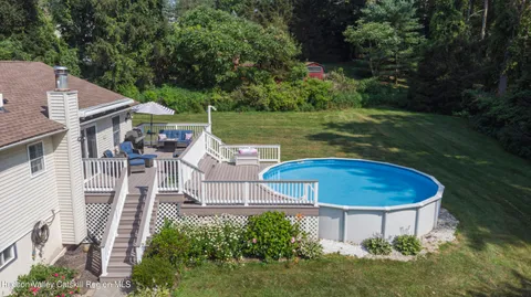 a view of a house with backyard porch and garden