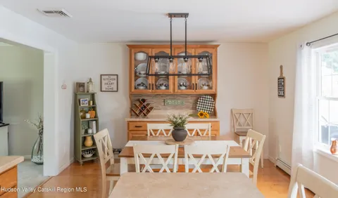 a dining room with furniture and window