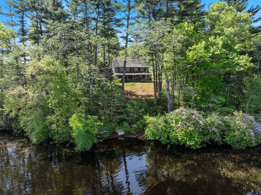 362 Snows Pond Road Rochester, MA 02770 - Photo 35 of 41 a view of a lake with a building in the background