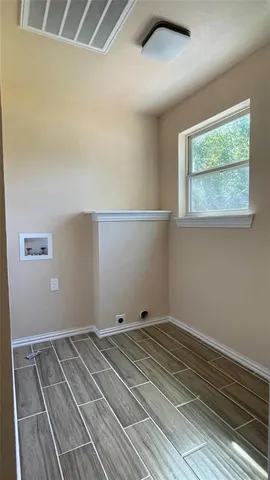 a view of a room with wooden floor and more cabinets