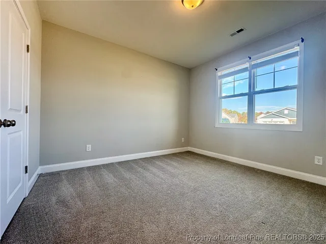 an empty room with closet area