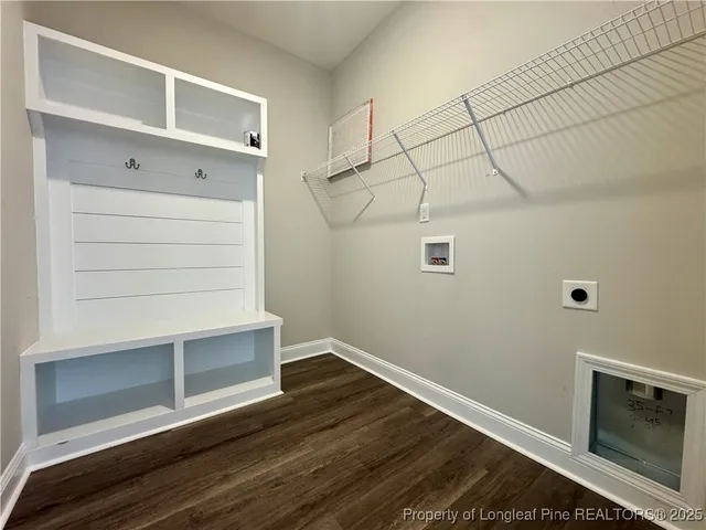 a view of an empty room with chandelier fan and a window