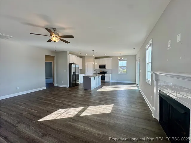 a kitchen with stainless steel appliances granite countertop a sink a stove and cabinets