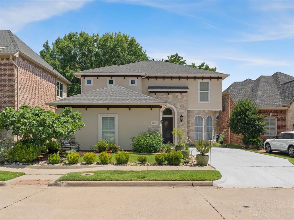 1615 Roma Lane Allen, TX 75013 - Photo 2 of 36 Stucco and stone facade with arched entry, complementing arched windows, and a concrete driveway