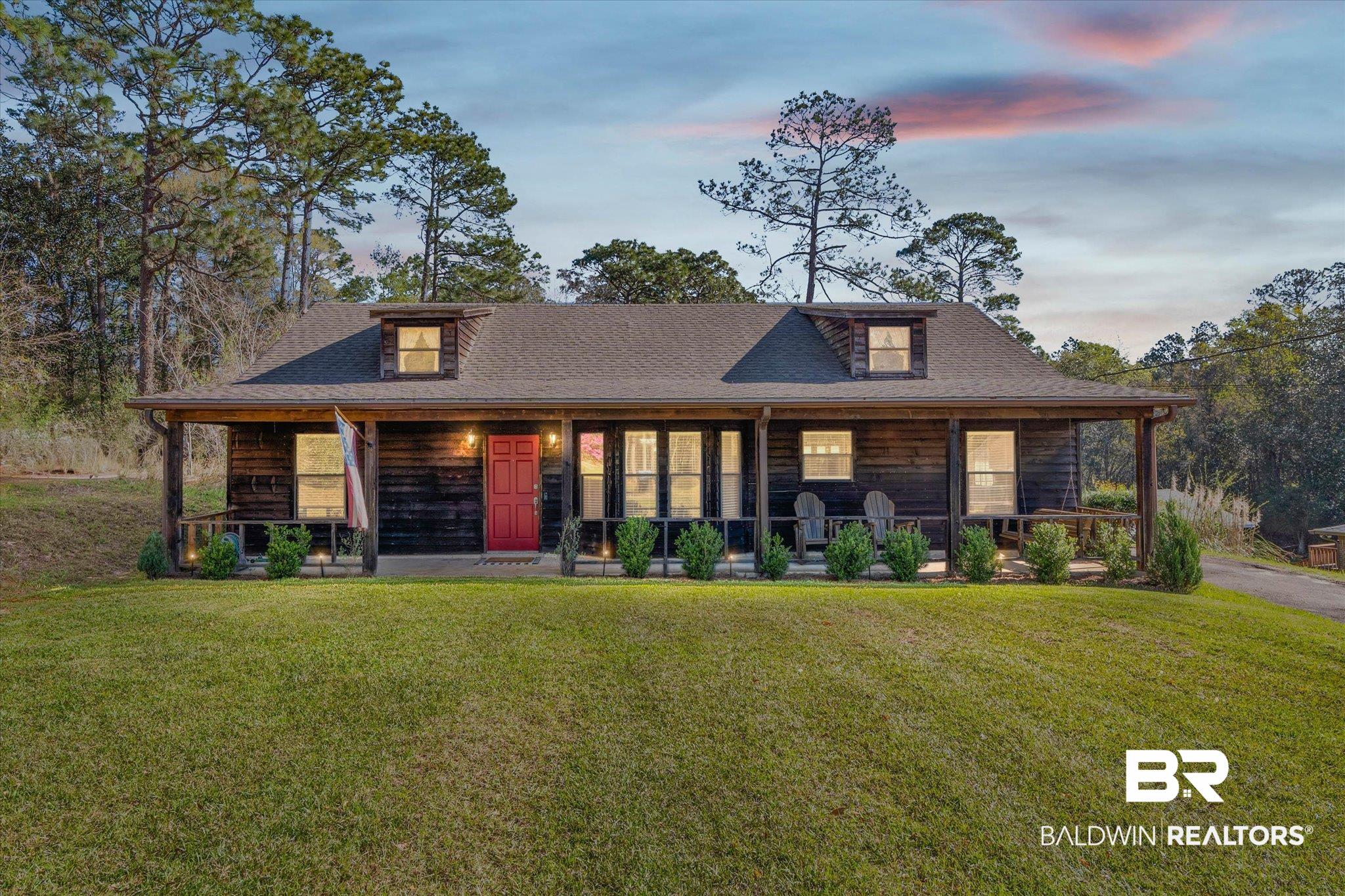 8030 Country Drive Mobile, AL 36619 - Photo 1 of 22 View of front of home with covered porch, a front yard, and a shingled roof