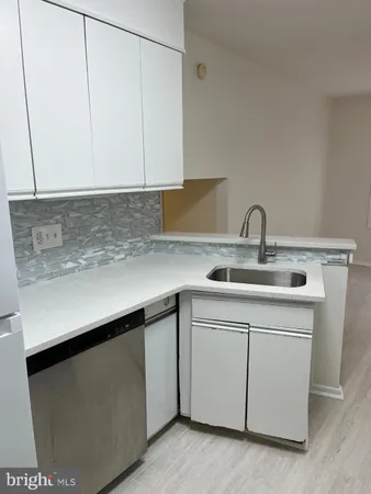 a kitchen with a sink and cabinets