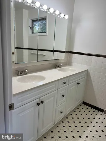 a bathroom with a sink a vanity and a mirror