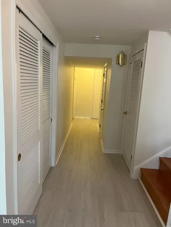 a view of hallway with livingroom and a window